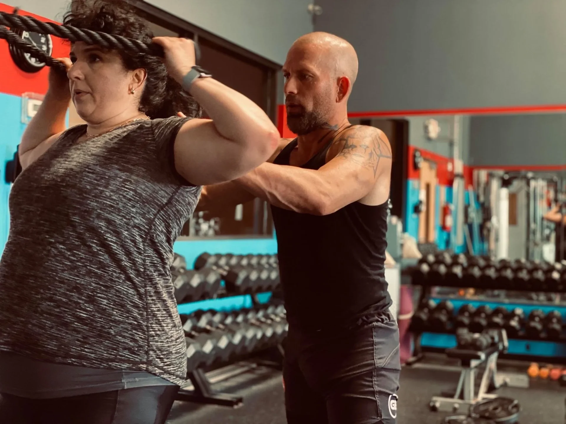 Woman and trainer in gym workout